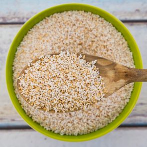 Popped organic amarant on wood spoon and in bowl