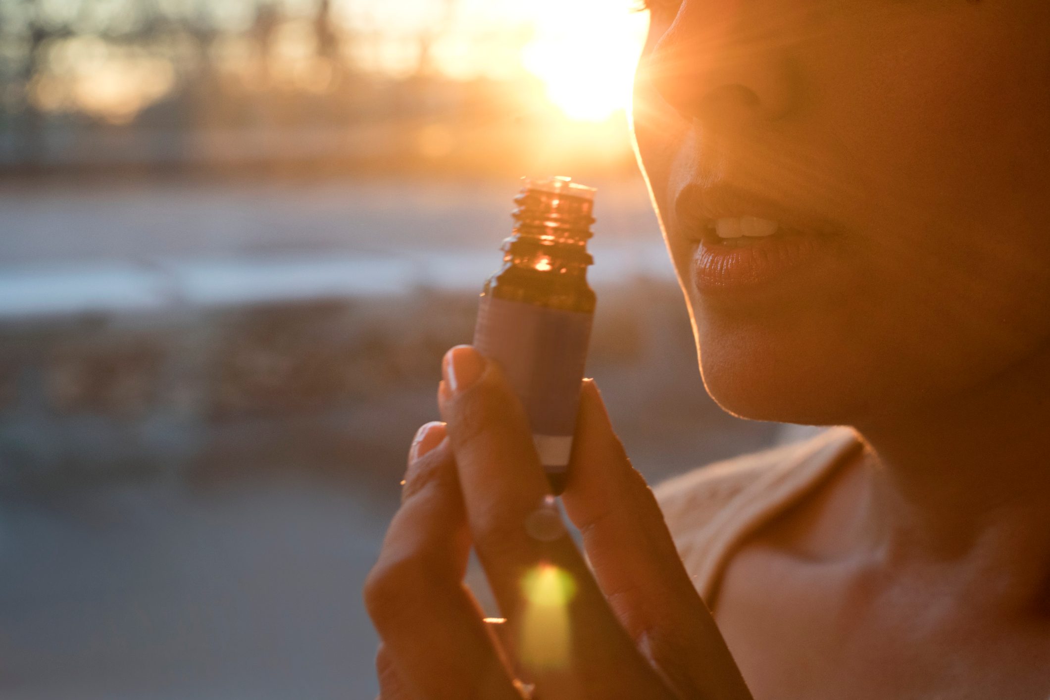 Woman holding essential oil bottle