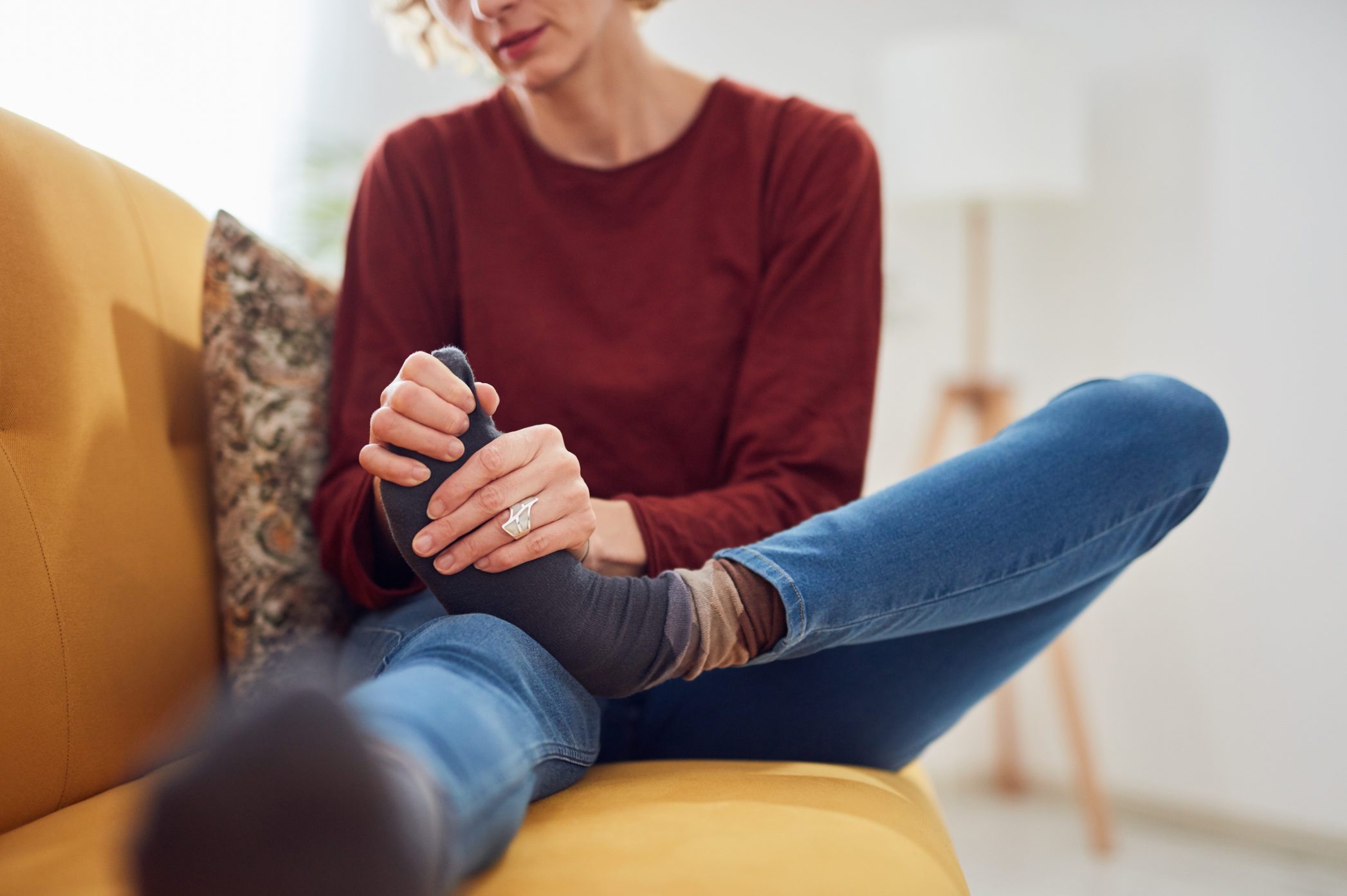 Woman rubbing foot, foot pain