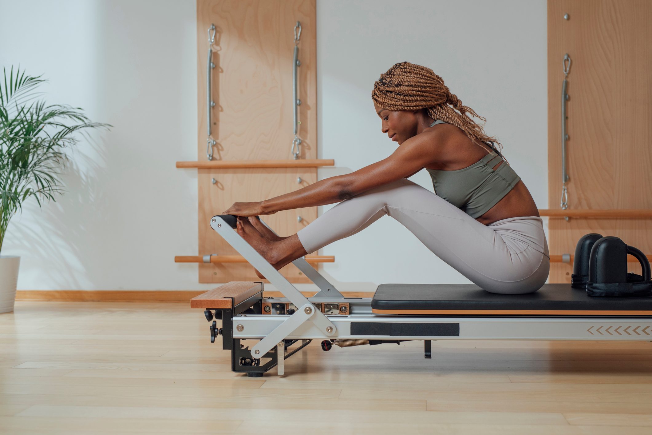Woman Doing Pilates Exercise on Reformer