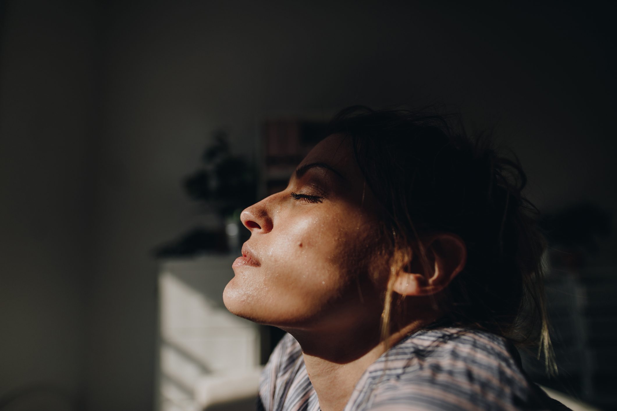 woman with eyes closed in the sunlight