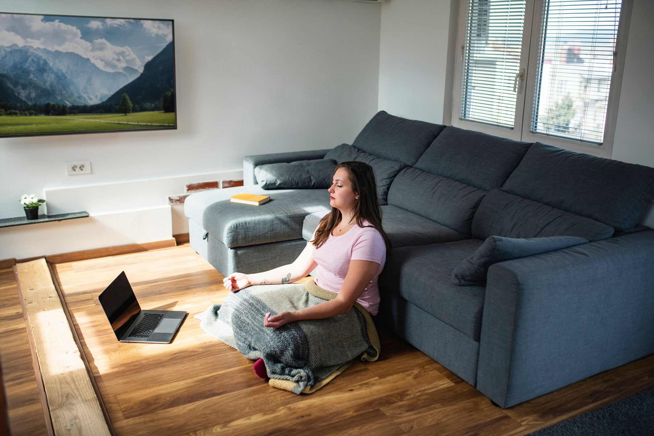 Woman Sitting on the Floor Listening to Guided Meditation