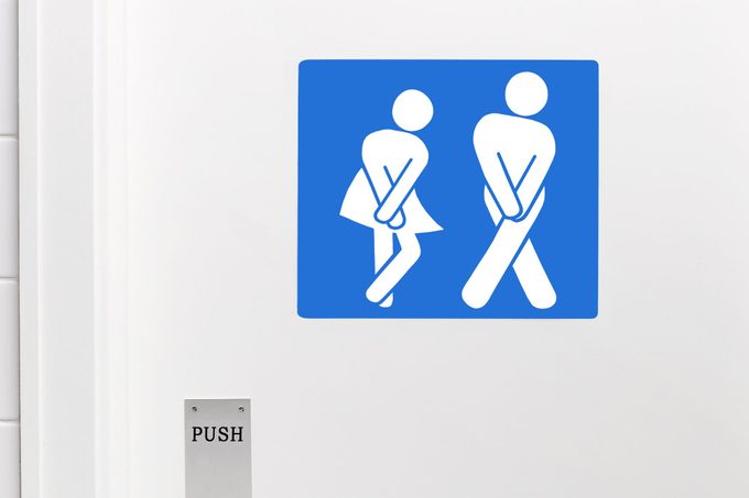 Gender neutral toilet sign, legs crossed urgent need to urinate