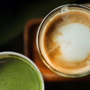 High Angle View Of Coffee And Juice On Table