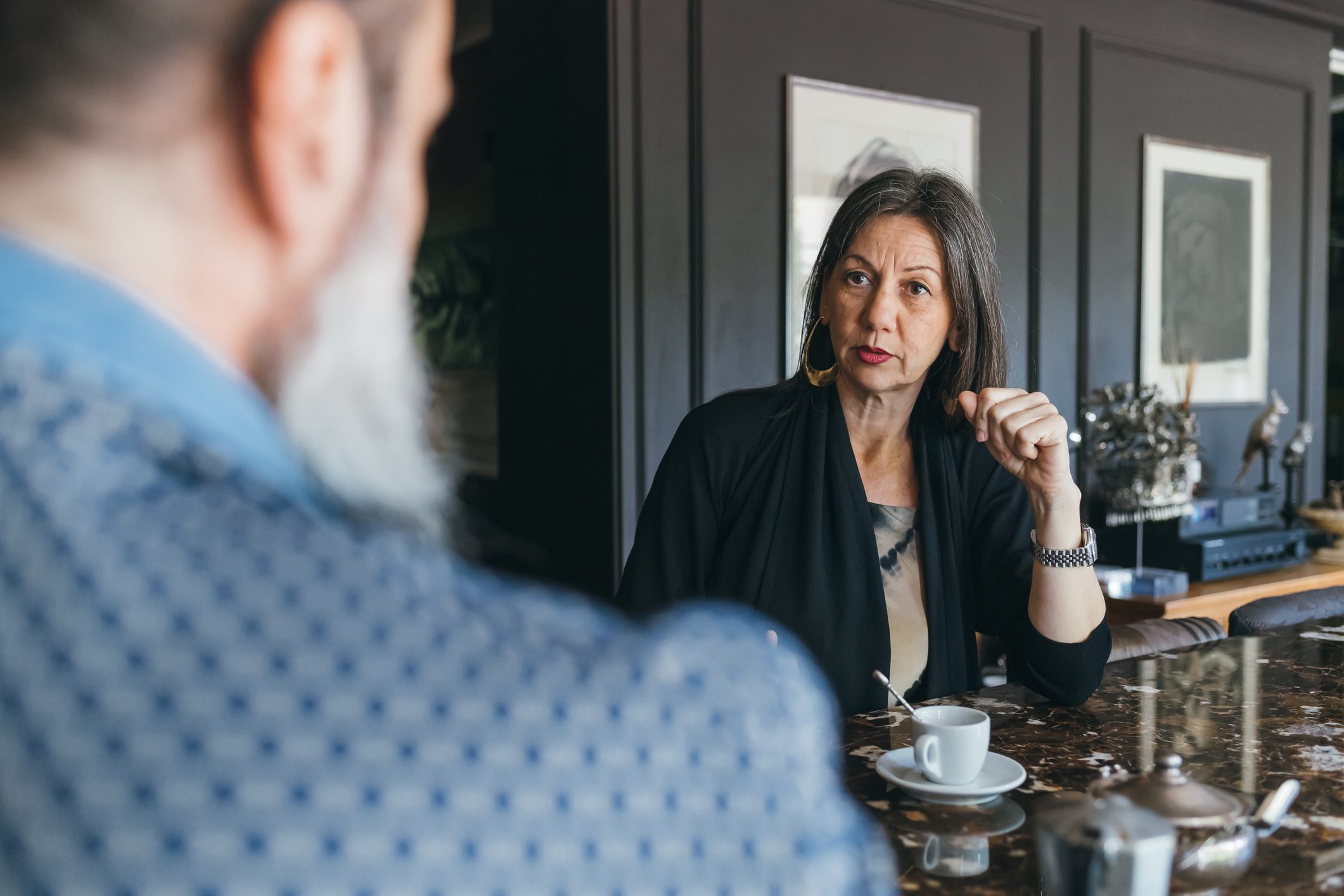 Couple in discussion over coffee in kitchen