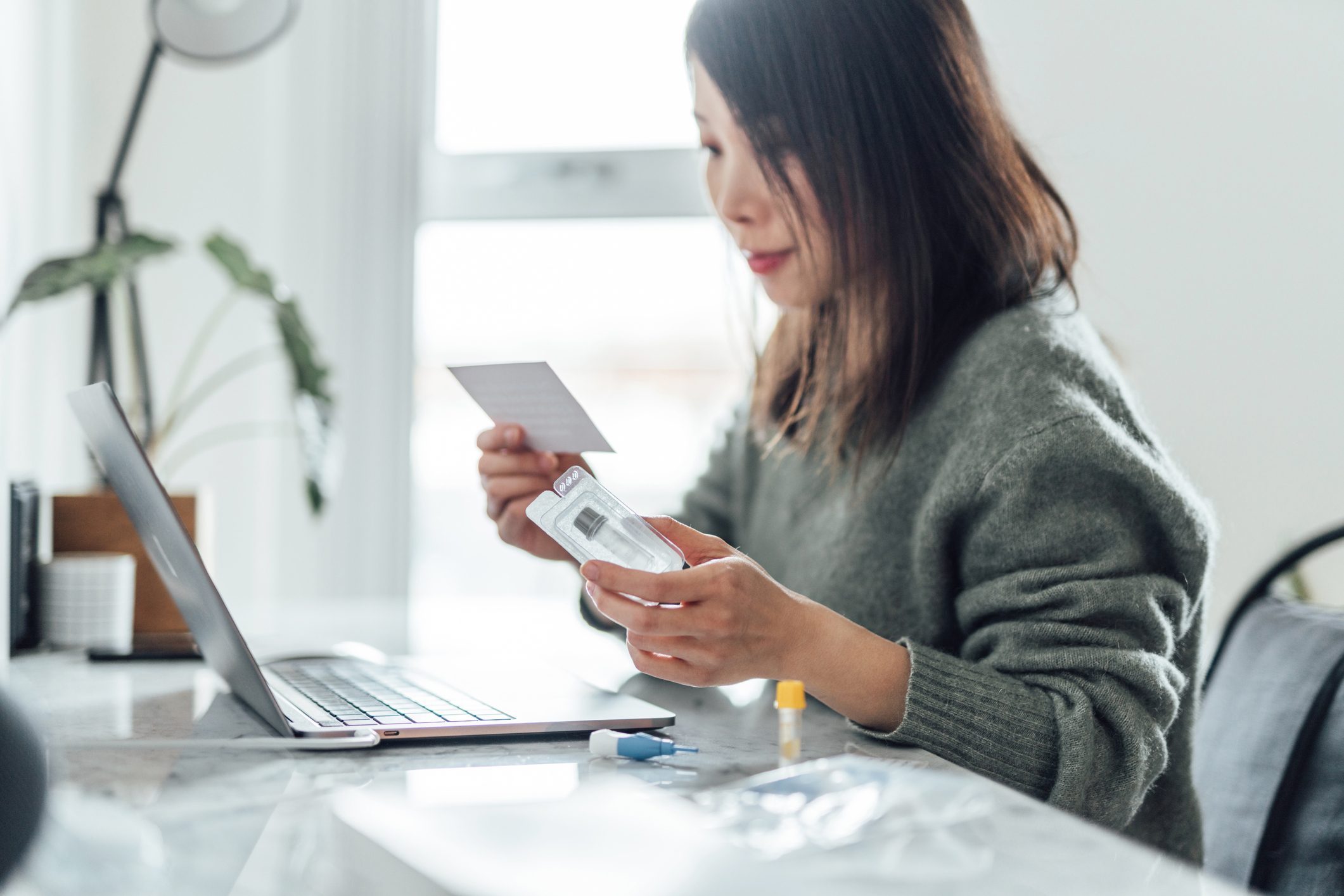 Young Woman Using Home Blood Test Kit