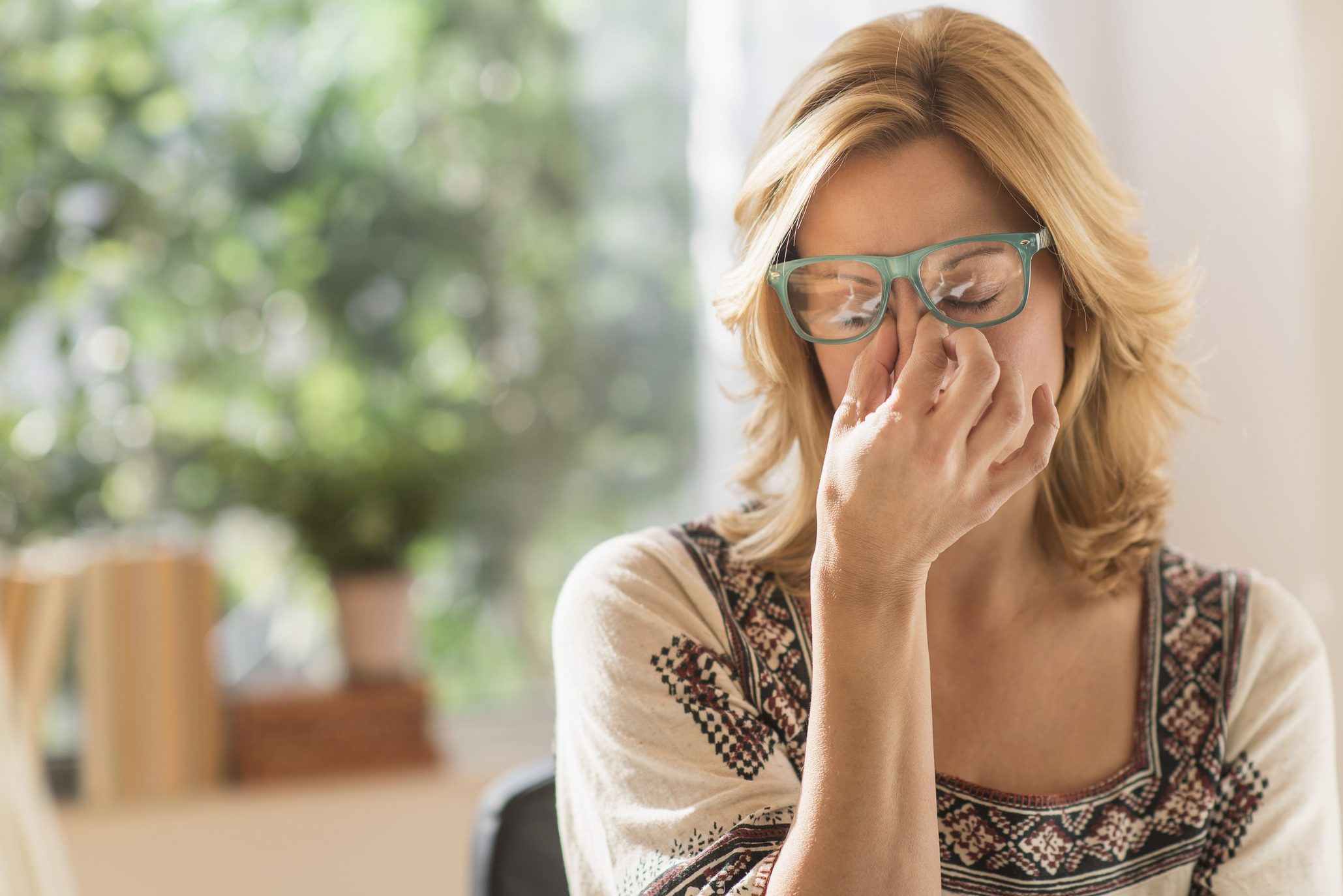 woman suffering from headache migraine at home