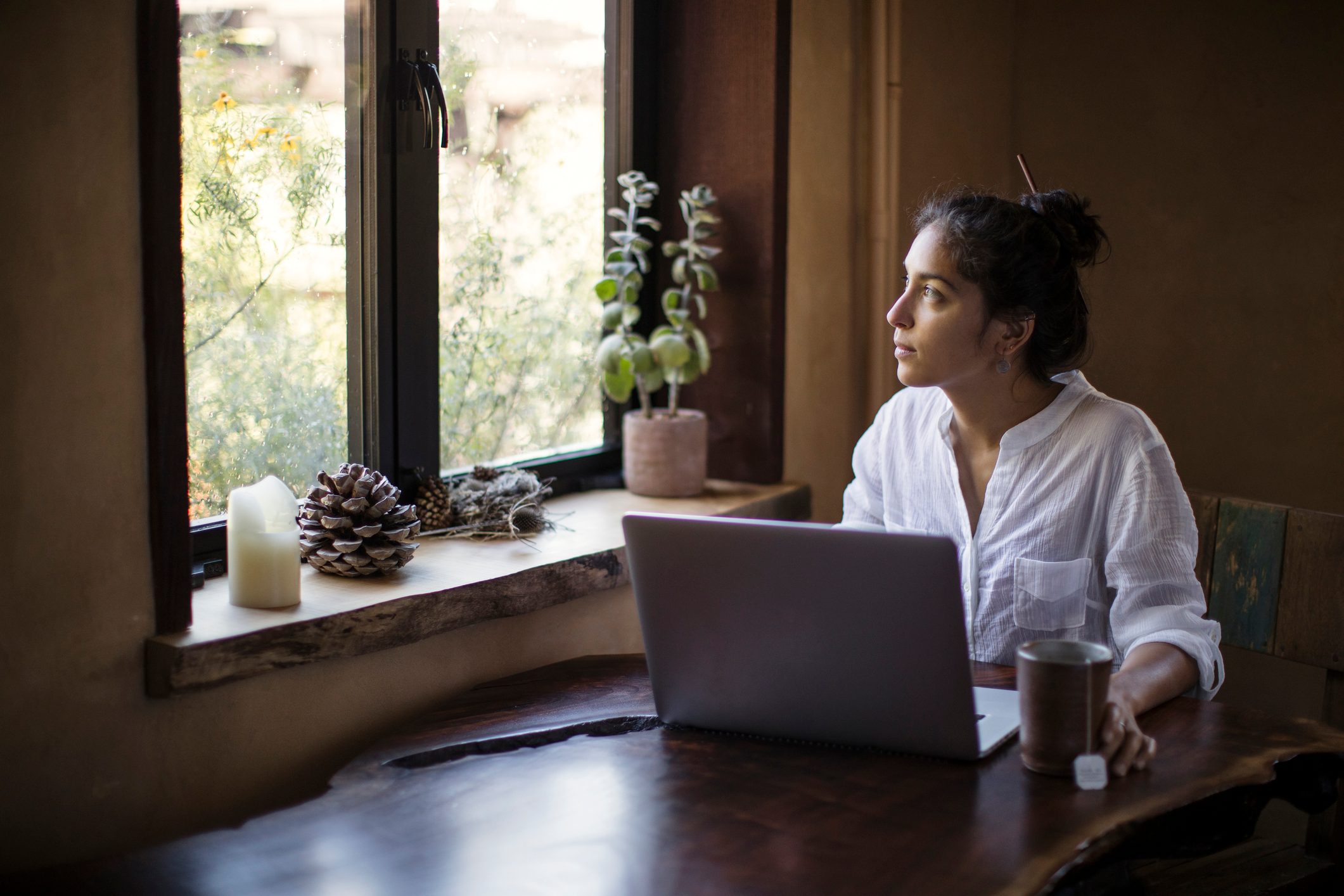 Mixed-race Young Adult Woman Works at Home Using Laptop Computer