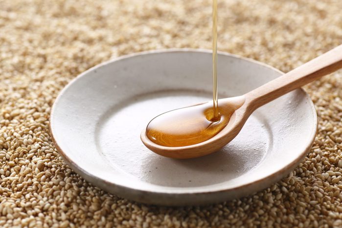 Pouring sesame oil into a small ceramic dish