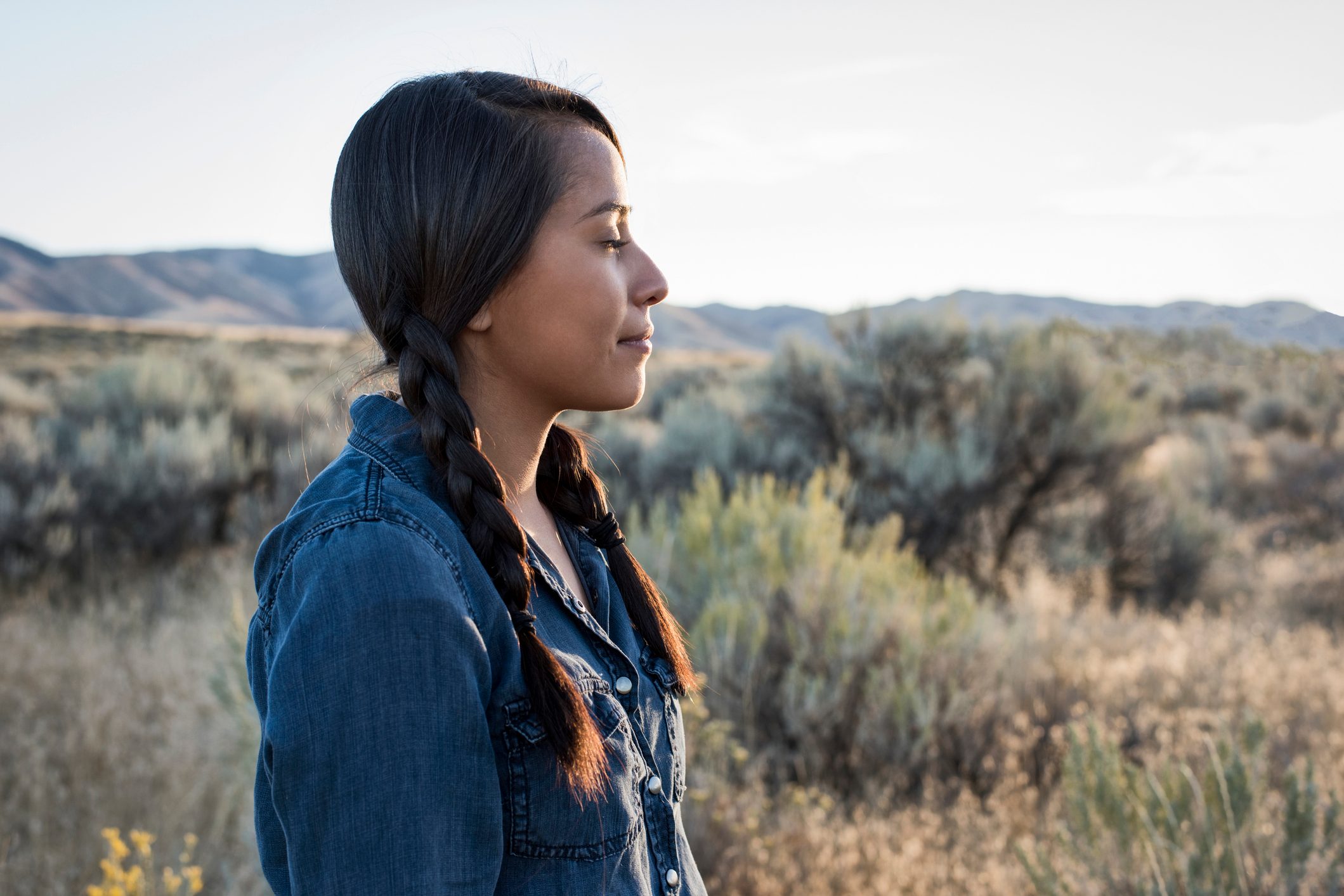 Young Native American woman outdoors at sunset