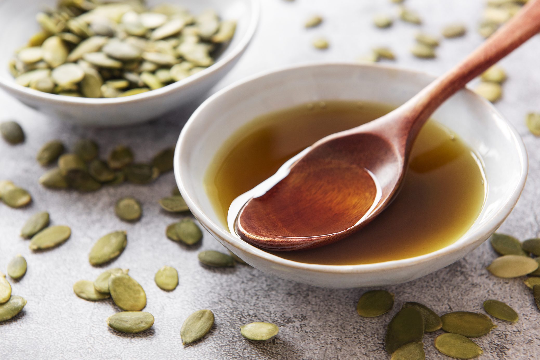 Bowl of pumpkin seed oil and pumpkin seeds