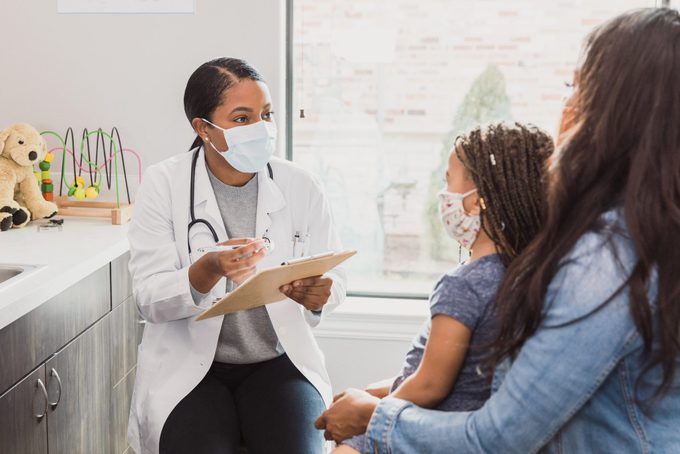pediatrician talking to mother of patient