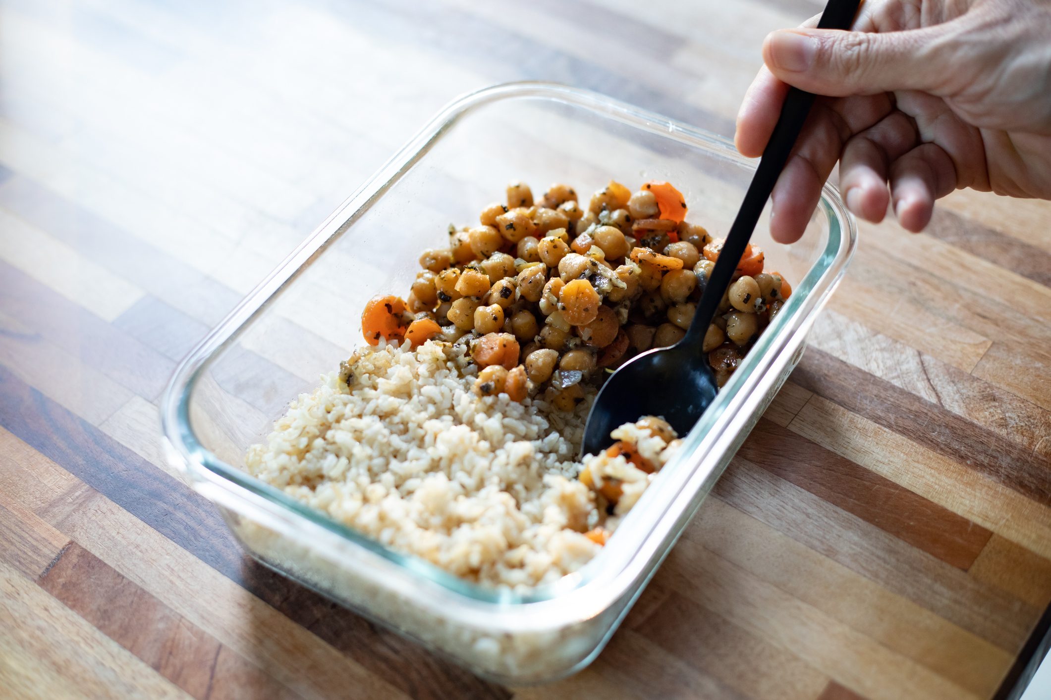 person eating food leftovers from container