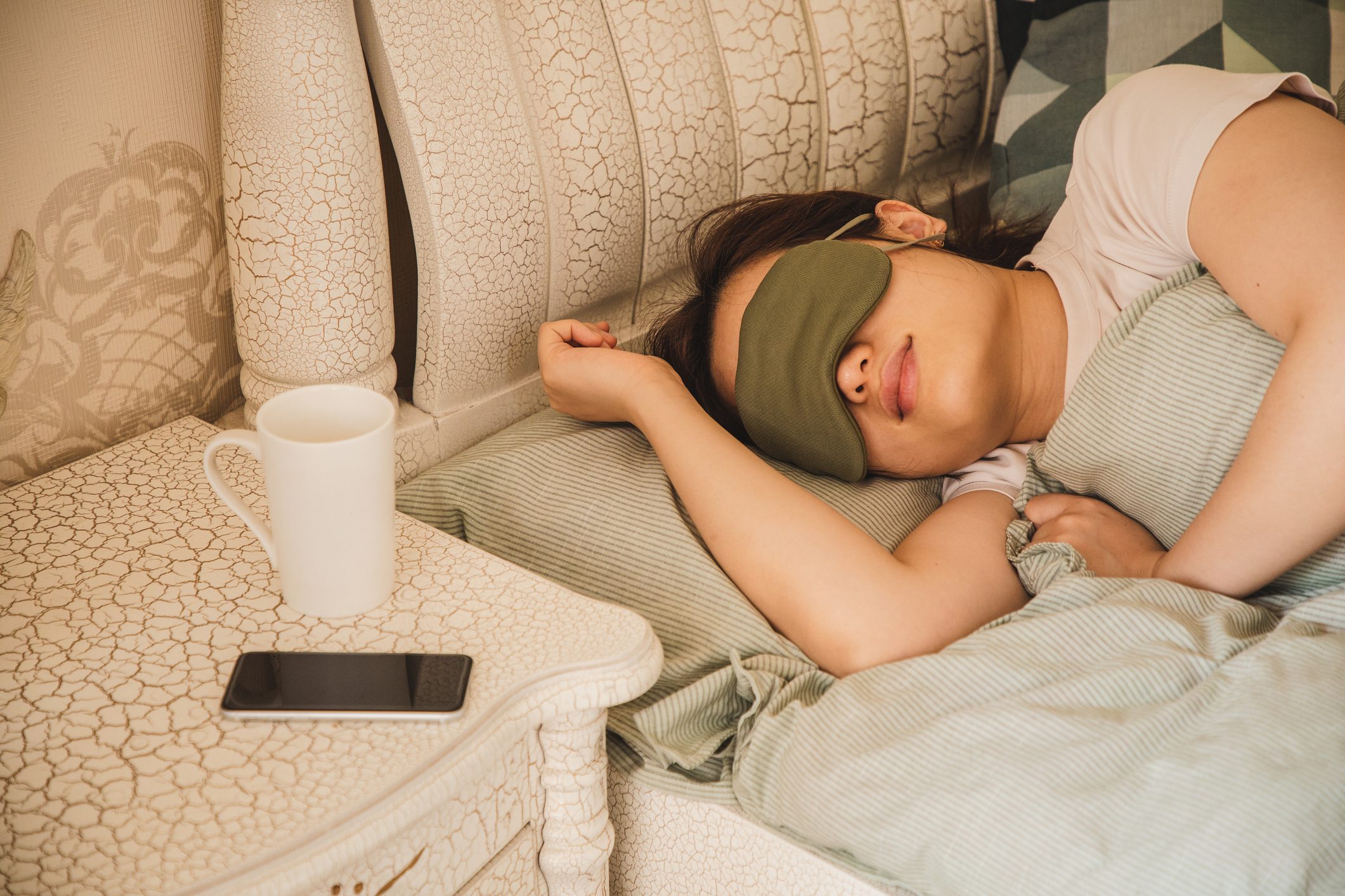 woman sleeping with eye mask on face