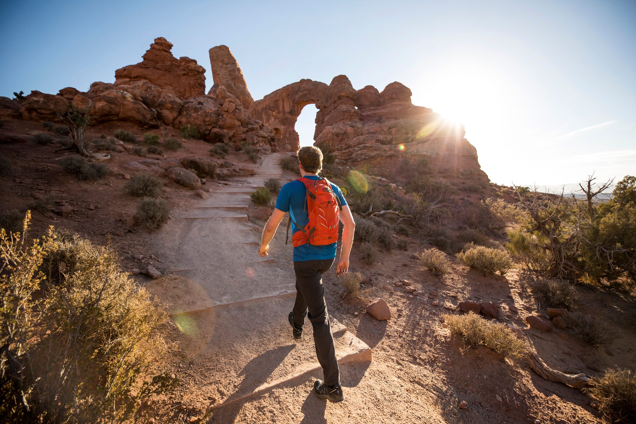 A man hiking in arches national park in Utah