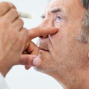 man getting eyes examined by an ophthalmologist