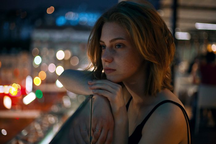 Pensive teenage girl leaning on railing