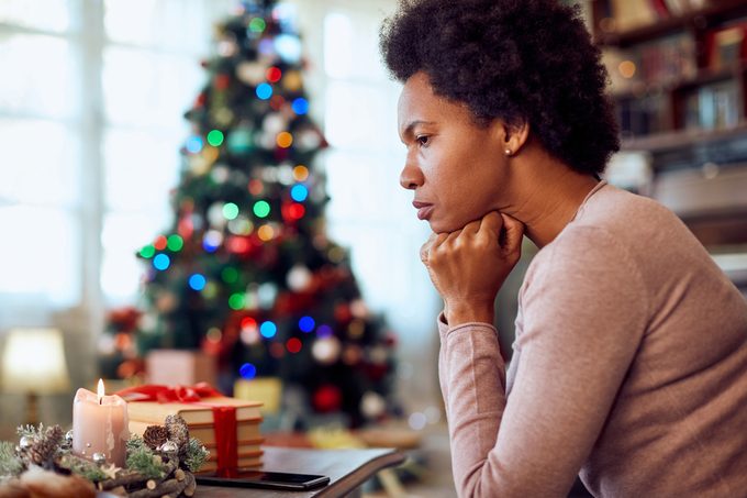 worried woman sitting near the christmas tree