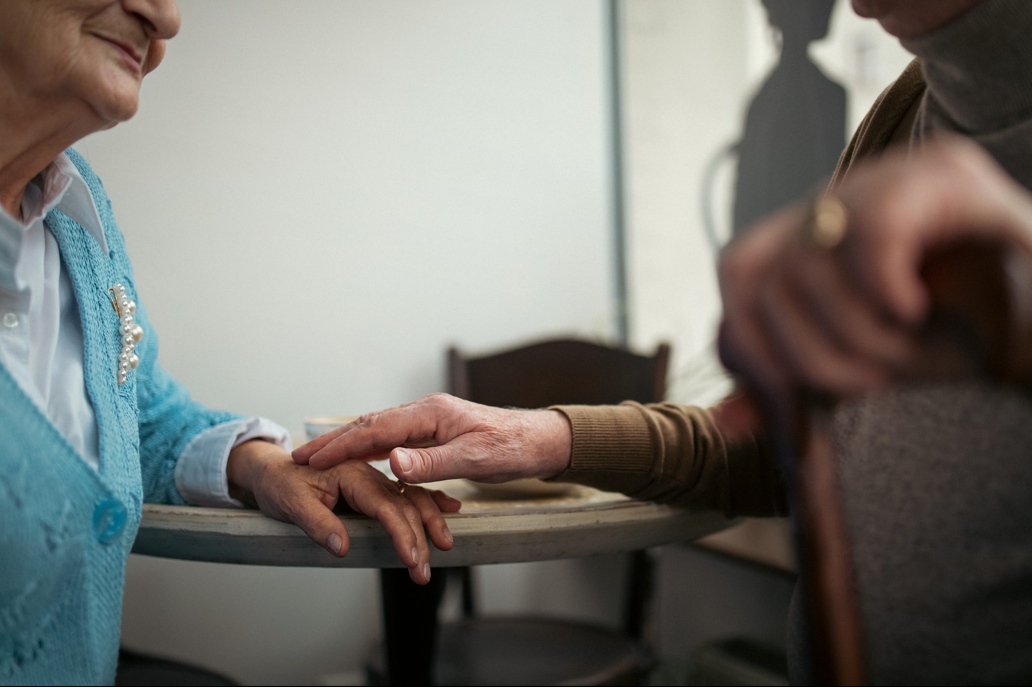 Unrecognizable senior couple talking inside cafe