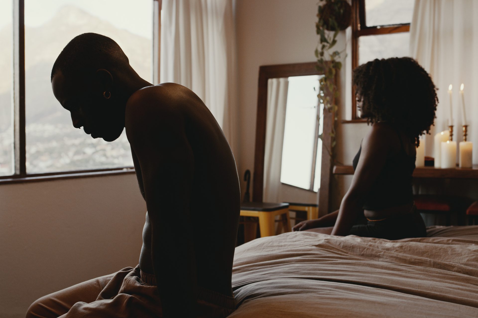 couple having an argument while sitting on the bed