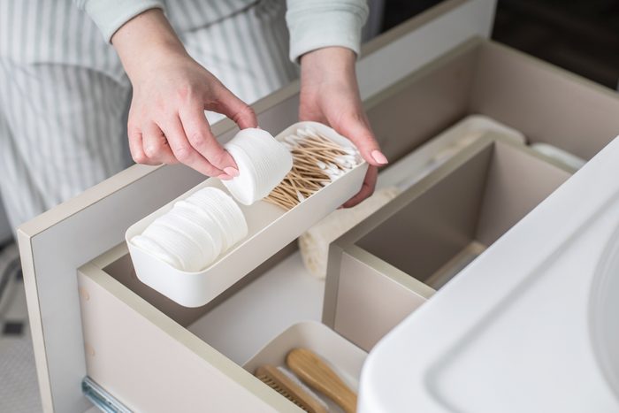 woman organizing bathroom bins