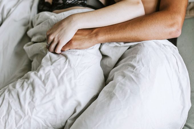 intimate couple laying in bed