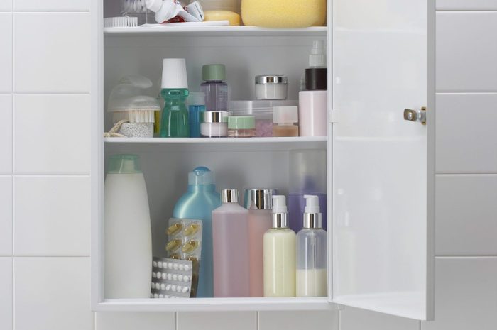 Various cosmetics and bath products in bathroom cabinet