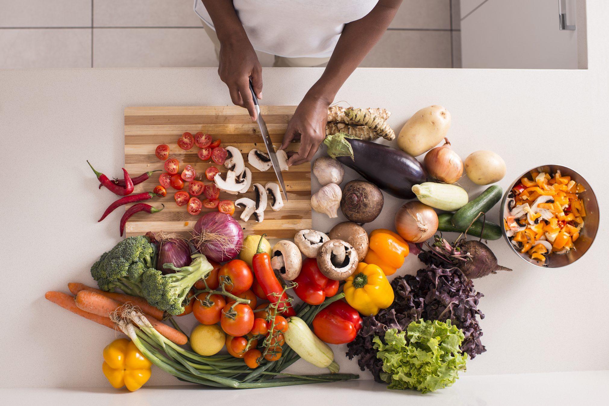 Unrecognized women preparing fresh healthy salad.