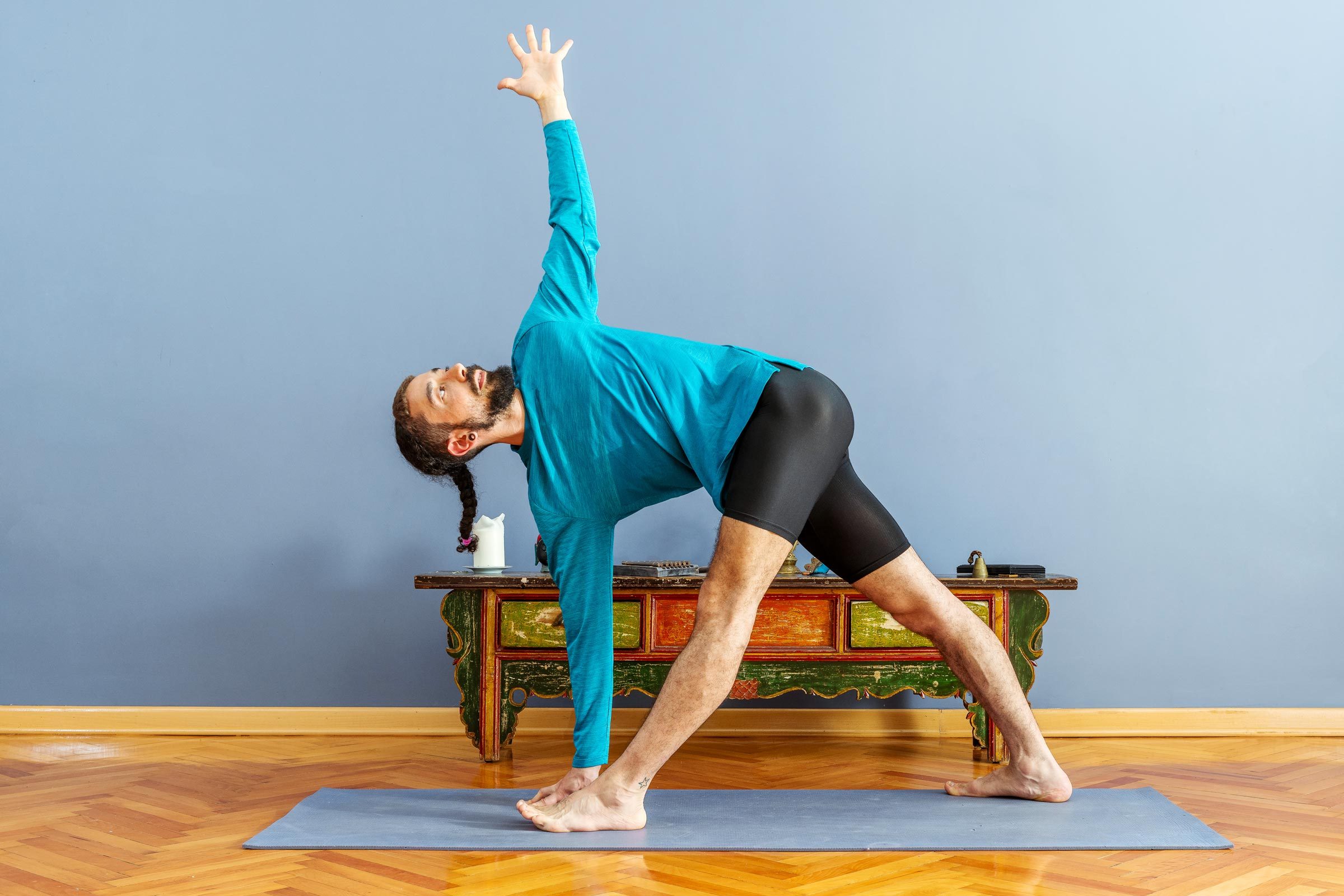 man inside on yoga mat does bone strengthening yoga pose, the reverse triangle