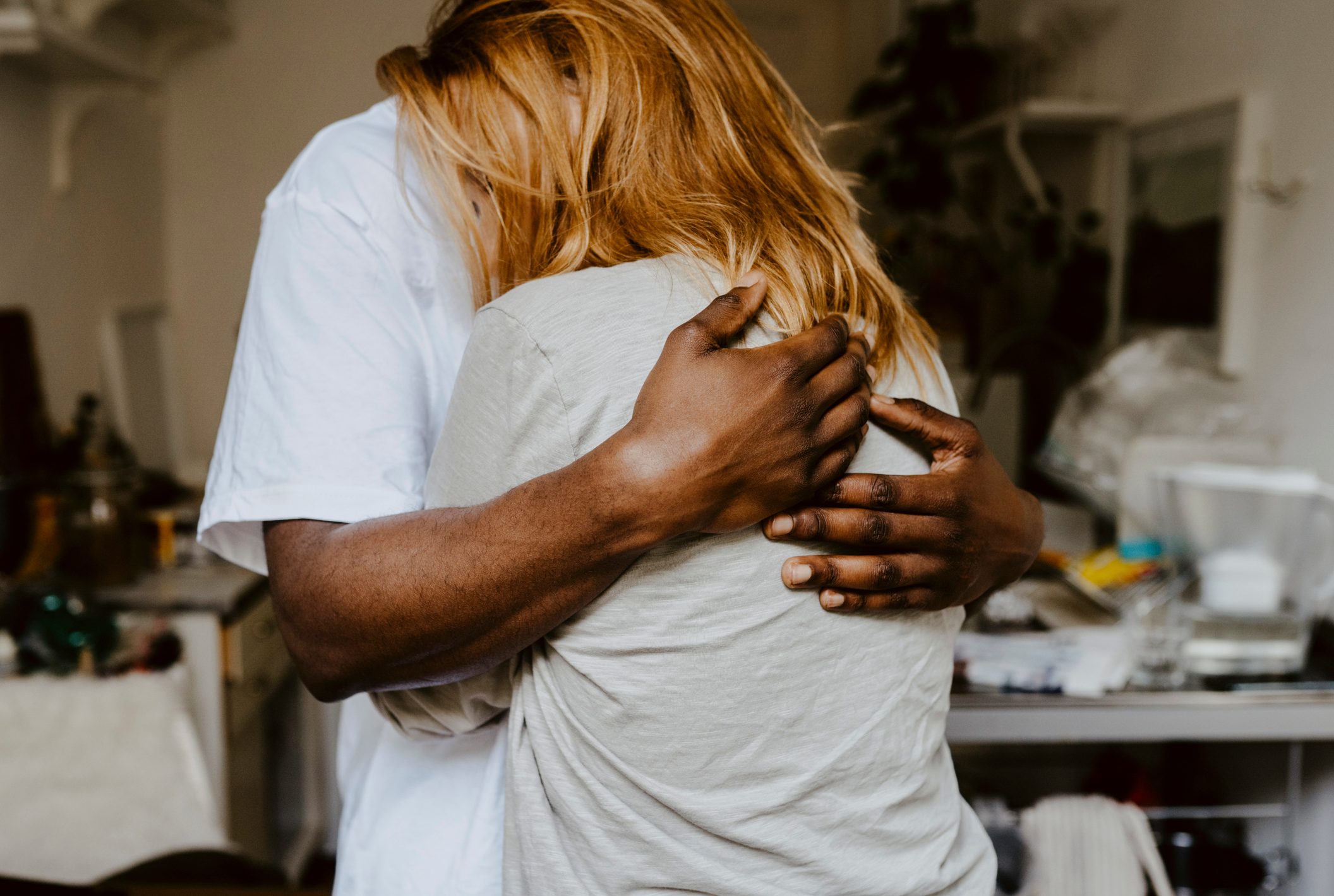 close up of a man embracing woman, both anonymous