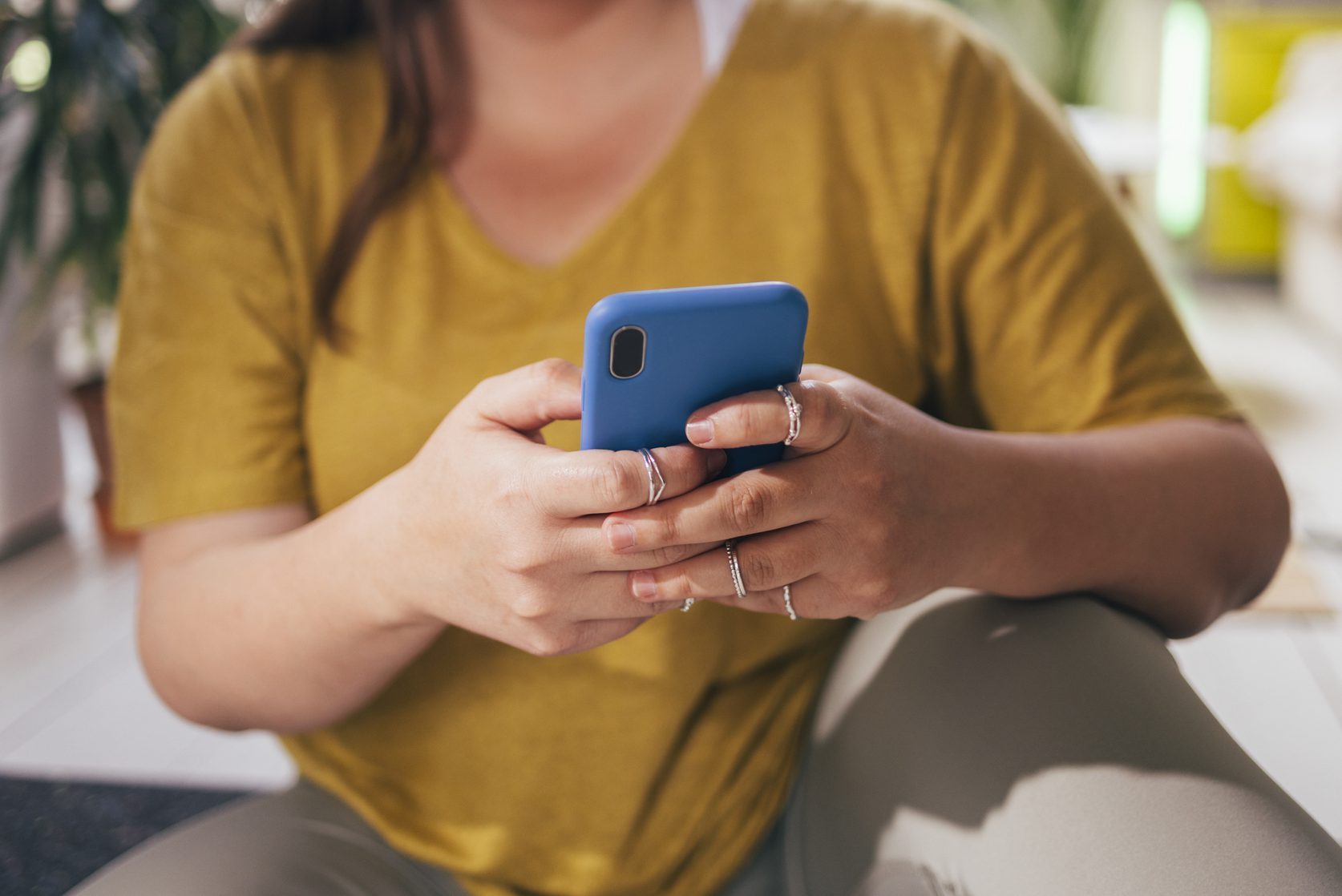 Anonymous Woman Texting On Smartphone