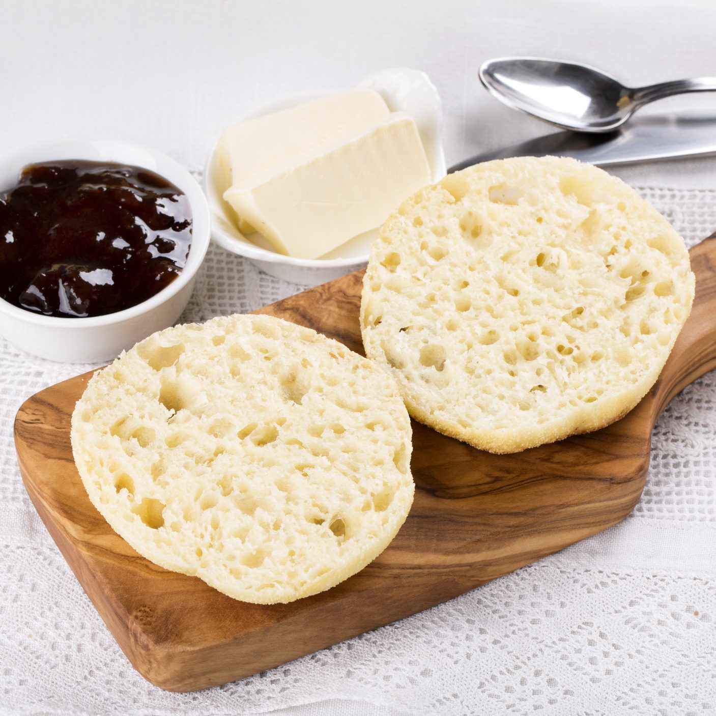 Fresh homemade English muffins with butter and jam