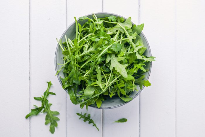Bowl with fresh green salad arugula rucola