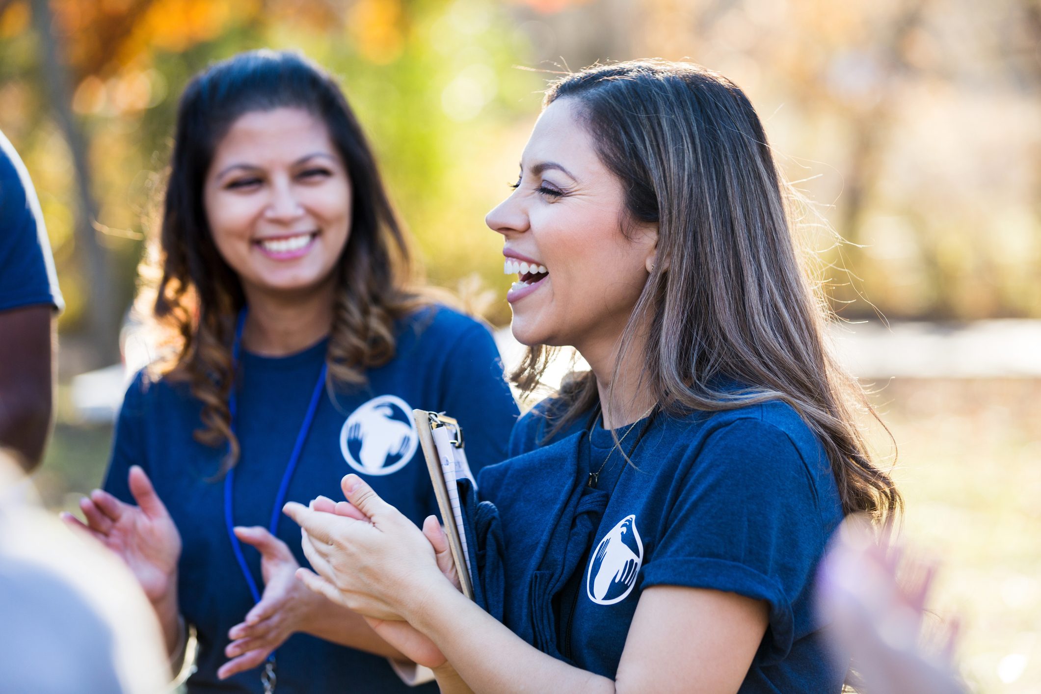 Volunteeers clap and smile before starting work