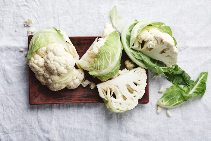 Fresh uncooked cauliflower cut into quarters