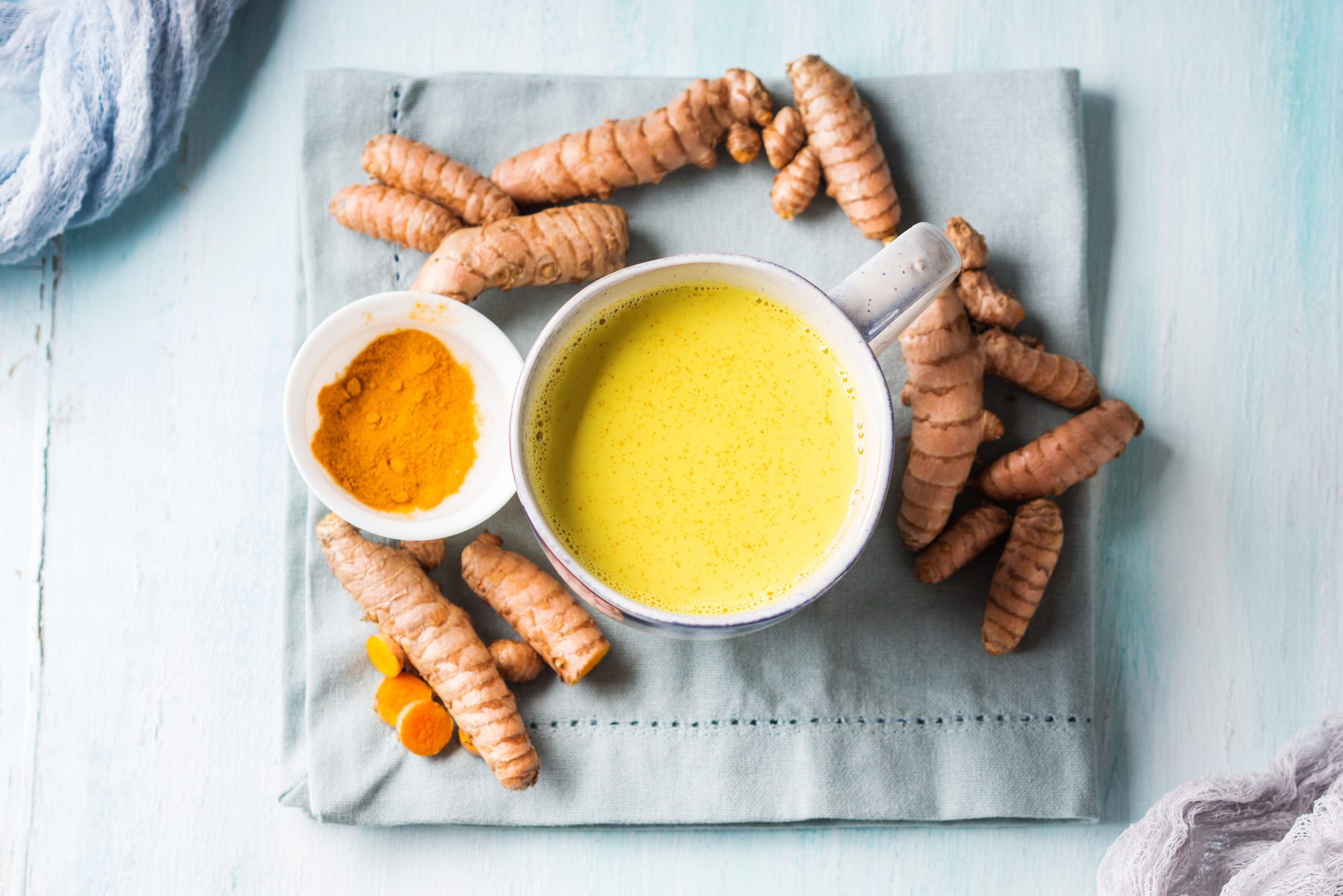 Directly Above Shot Of Turmeric Milk With Ginger On Table