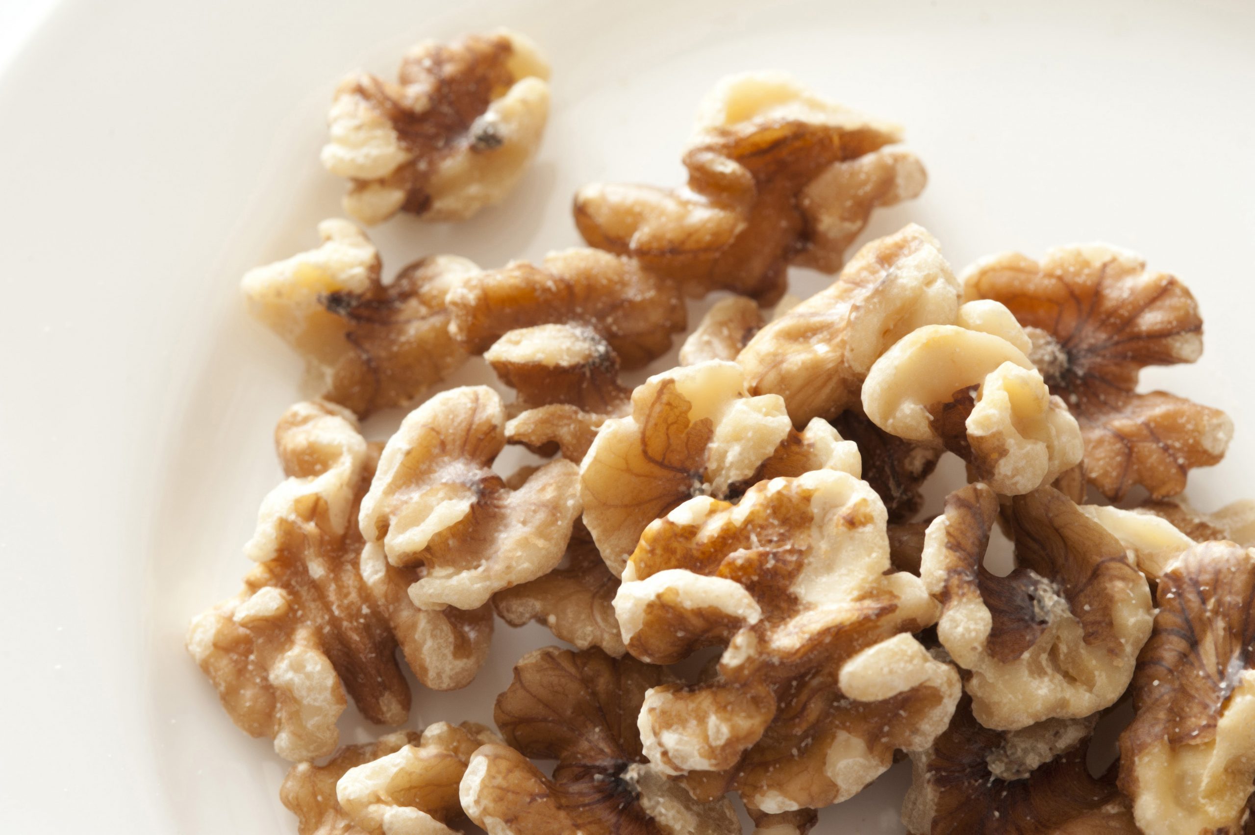 Pile of walnuts on white plate