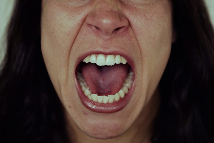 Young woman screaming, close-up