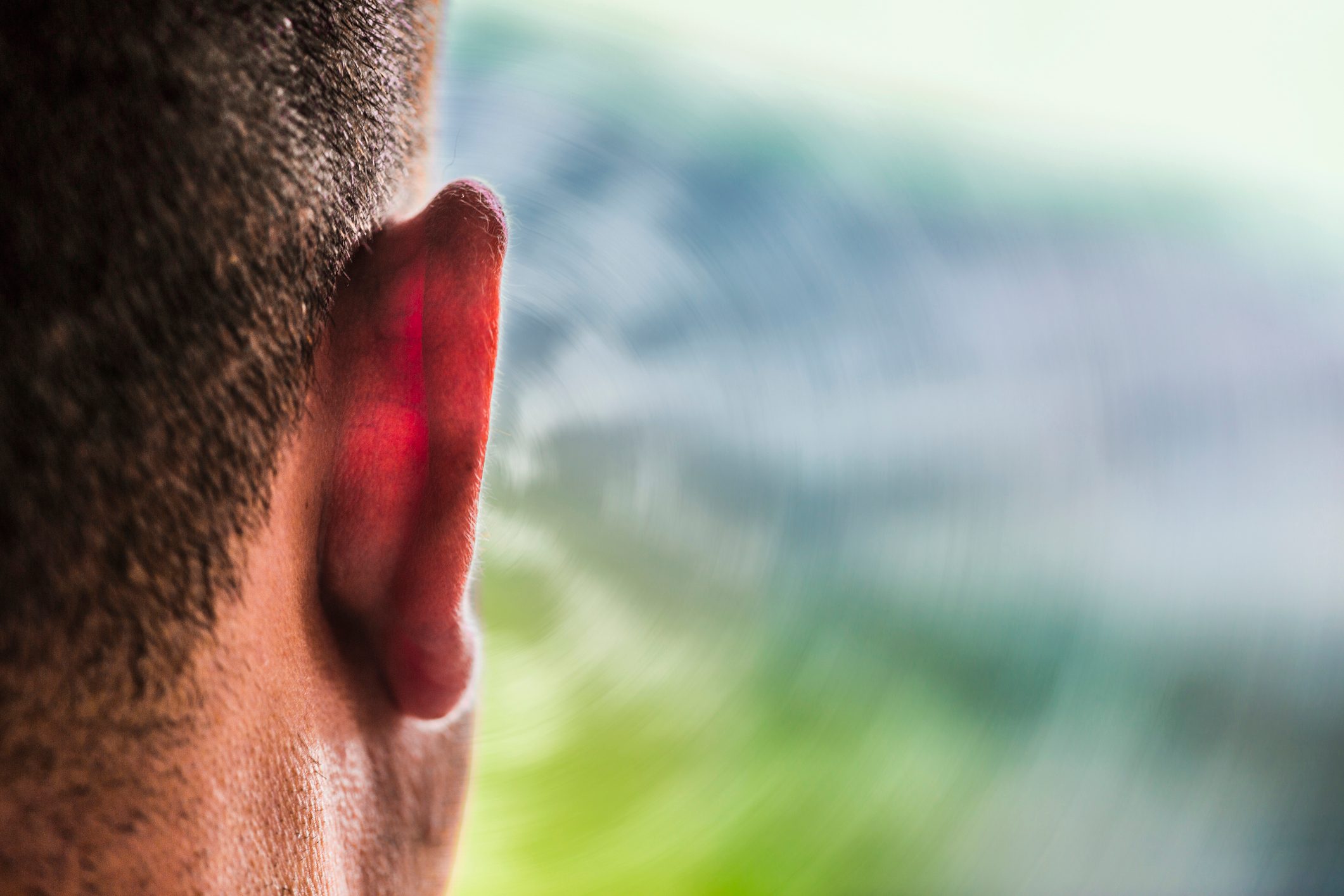 close up of man's ear from behind, outdoors