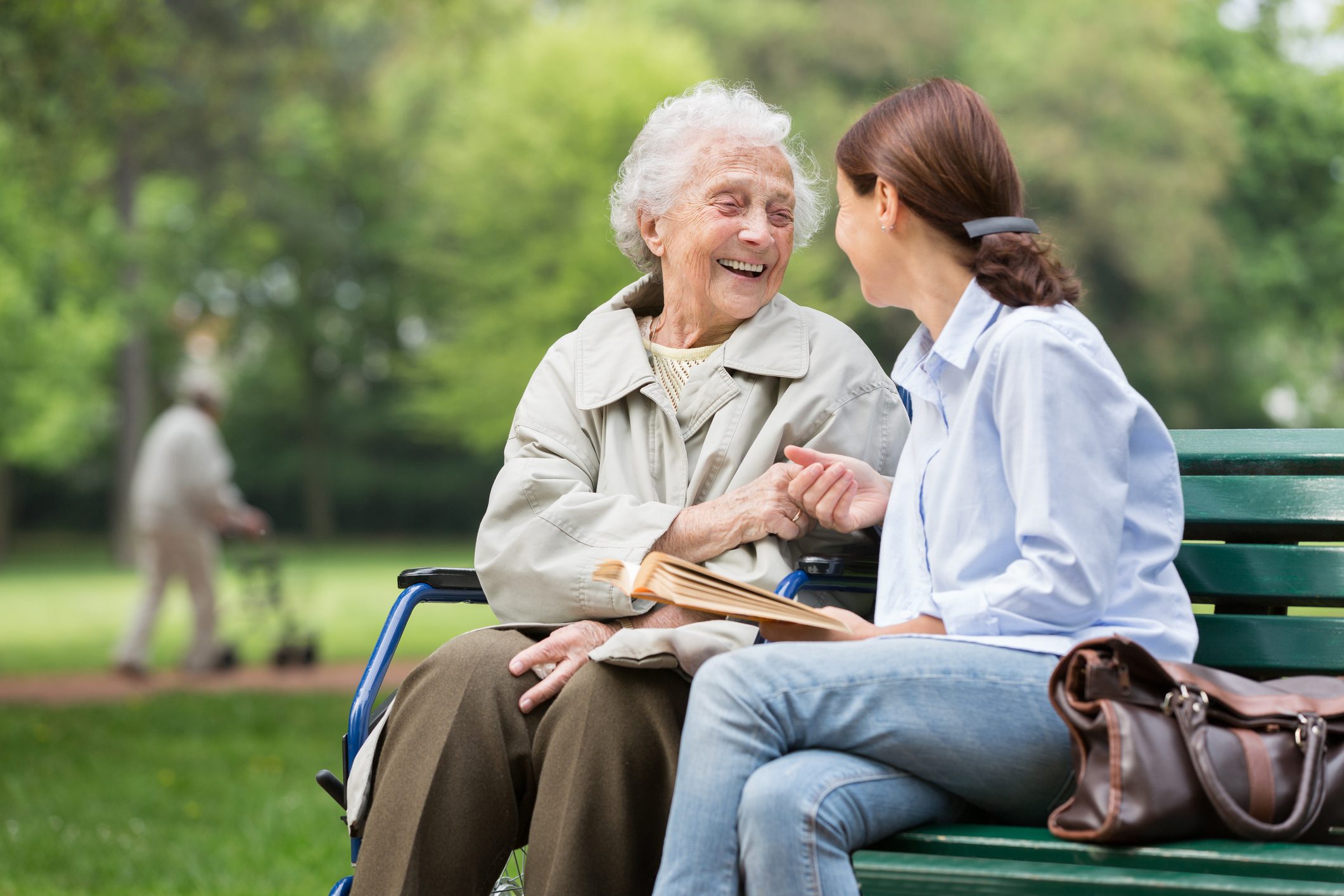 Senior woman with caregiver in the park