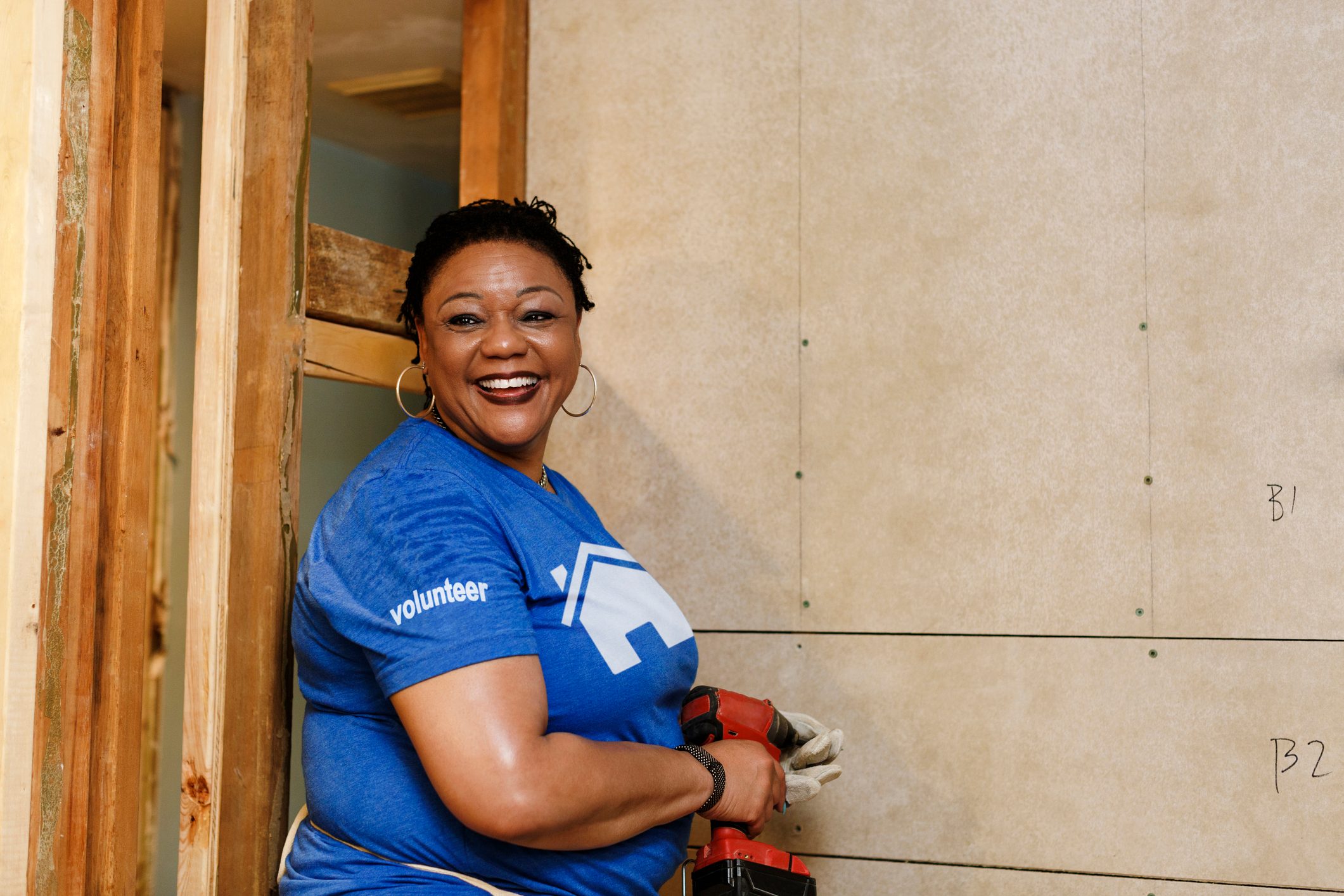 Portrait of smiling woman holding drill