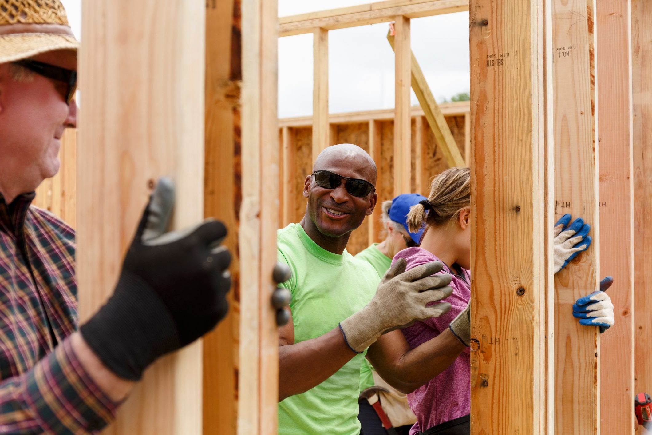 Volunteers holding wall at construction site