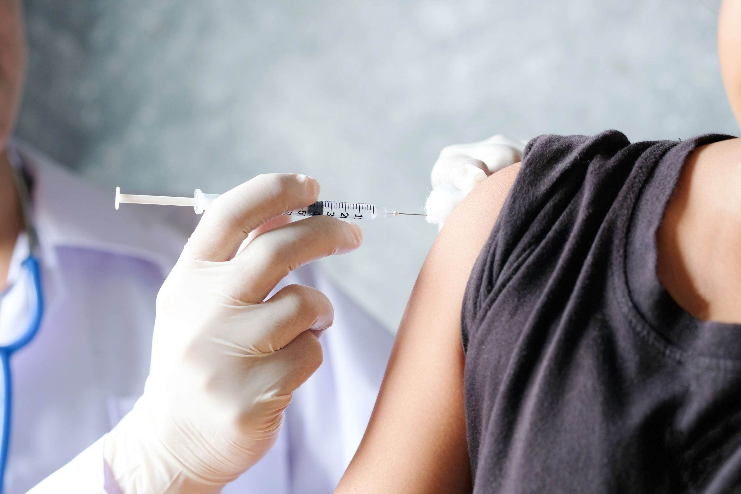 doctor giving a patient a birth control injection in the arm