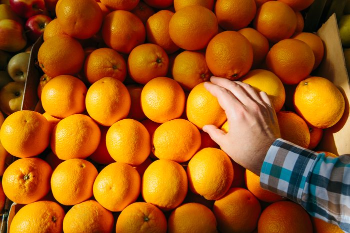 Man buying oranges at the farmer's market, personal perspective point of view