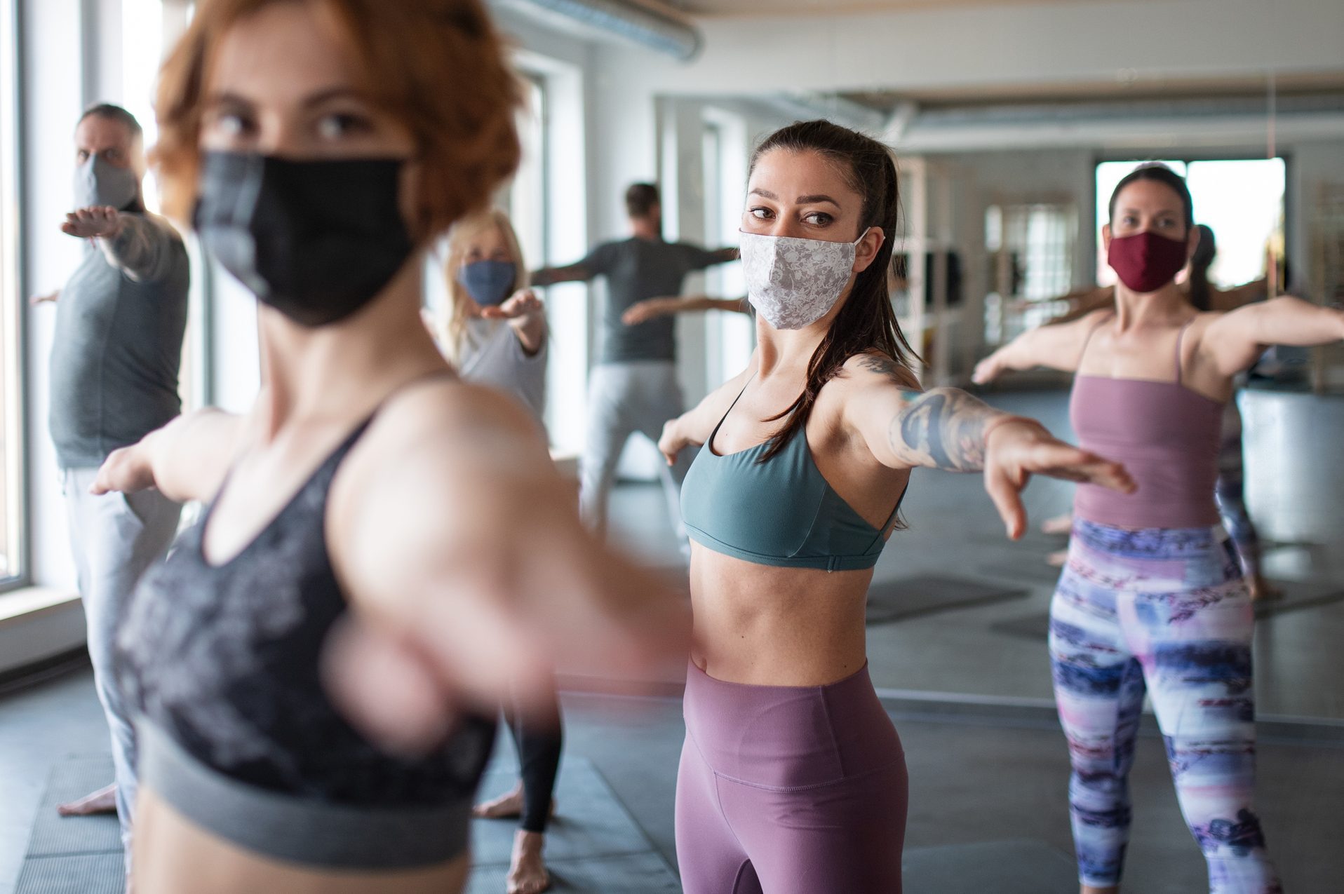 Group of women doing exercise in community center, coronavirus concept.