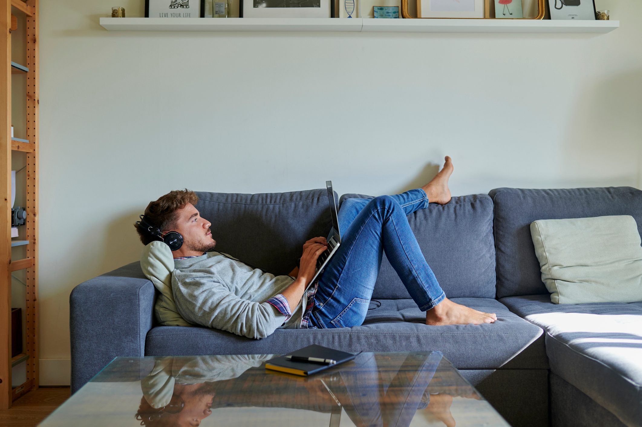 Man using laptop in living room at home