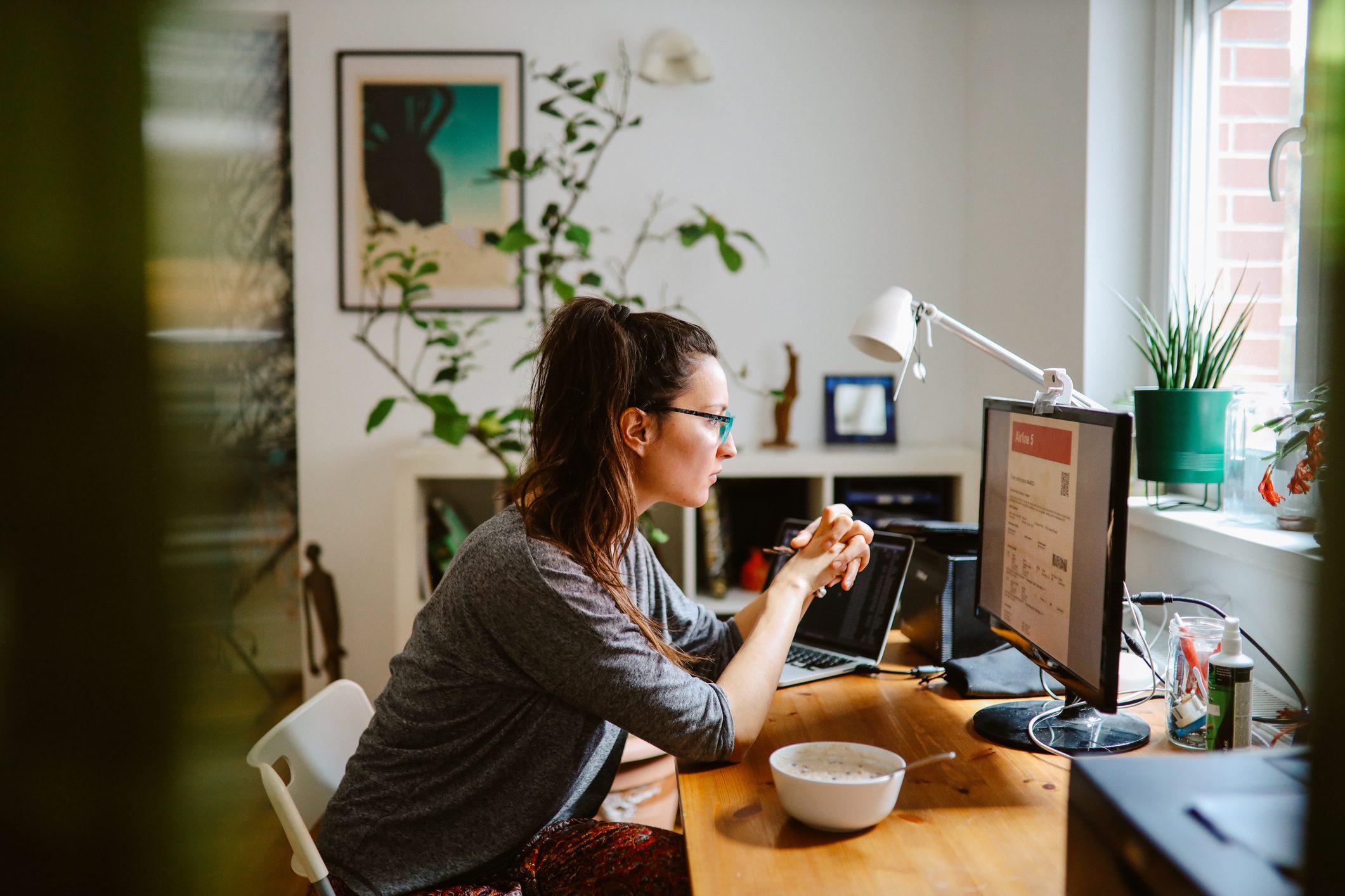 woman checking her online flight tickets at home