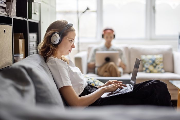 Young woman working at laptop at startup office