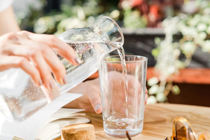 Woman pouring a glass of water