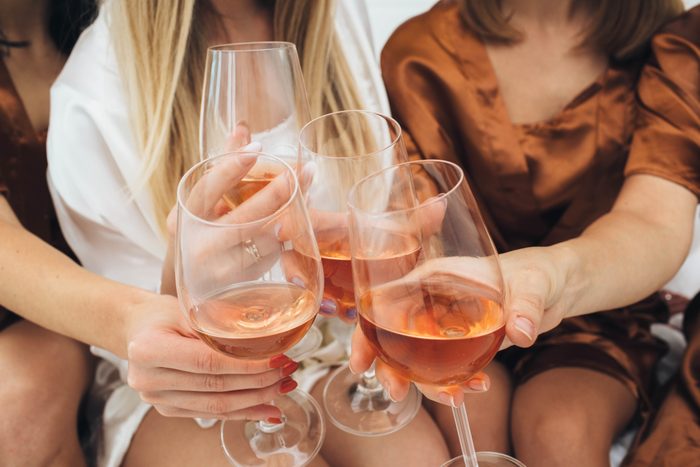 clinking glasses, enjoying pajamas party with girlfriends